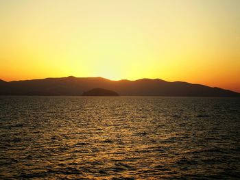 Scenic view of calm sea at sunset