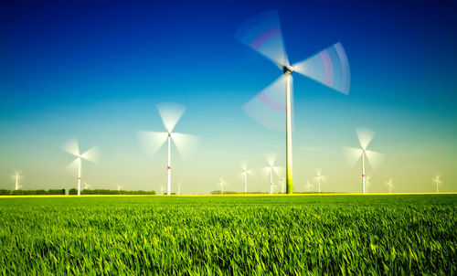Windmill on field against sky