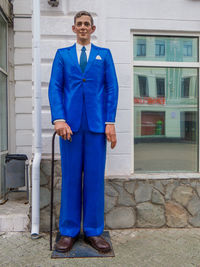 Portrait of smiling man standing against building