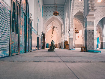 Rear view of man sitting in temple outside building