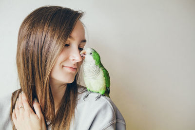 Close-up of young woman against white background