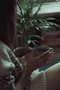 Woman holding coffee cup