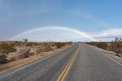 Rare rainbow over joshua trees in the desert of joshua tree national park