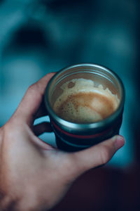 Close-up of hand holding coffee cup