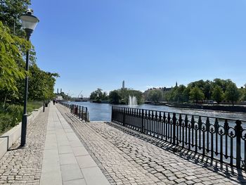 Pier over river against clear sky