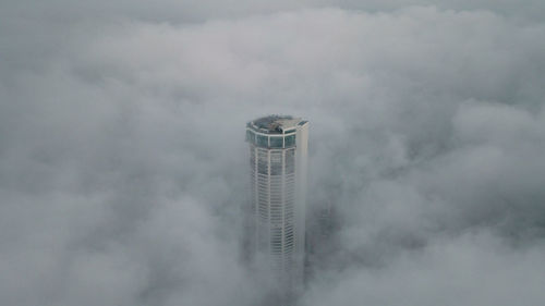 Low angle view of tower against cloudy sky