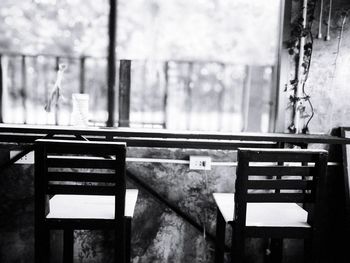 Empty bench on table by window