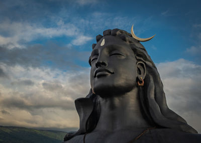 Low angle view of statue against sky