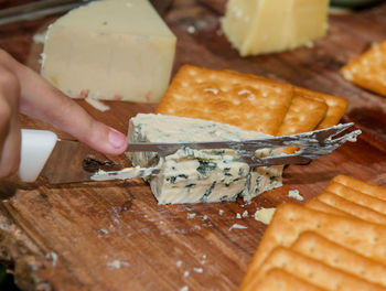 Close-up of person preparing food on cutting board