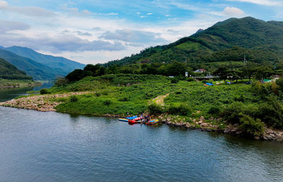 Scenic view of sea and mountains against sky