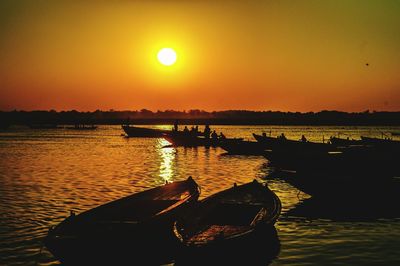 Silhouette boat in sea against clear sky during sunset