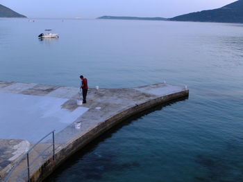 Rear view of woman in sea against sky