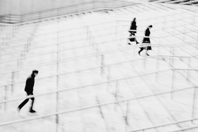 High angle view of people walking on snow