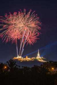 Low angle view of firework display at night