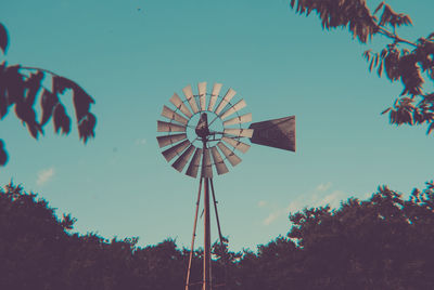 Low angle view of traditional windmill against sky