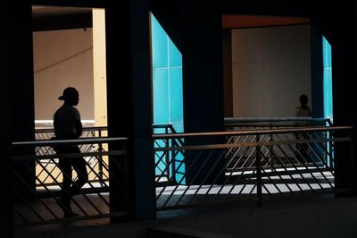 Man standing on railing