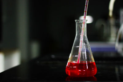 Close-up of red chemical in flask