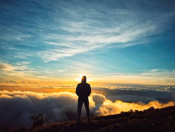 Silhouette man looking at sunset