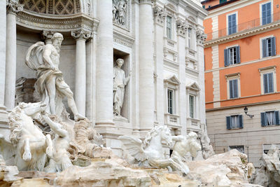 Low angle view of statue against building in city