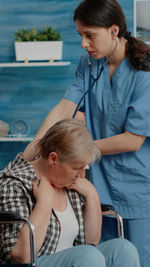 Nurse examining patient in clinic