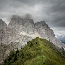 Scenic view of dolomites mountains against cloudy sky