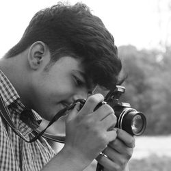 Close-up portrait of man holding camera