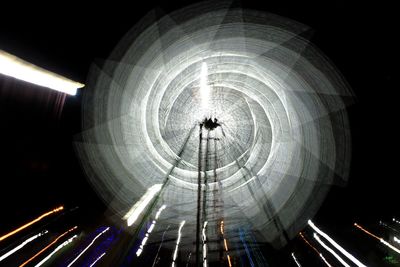 Low angle view of illuminated ferris wheel at night