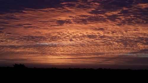 Silhouette of landscape against dramatic sky