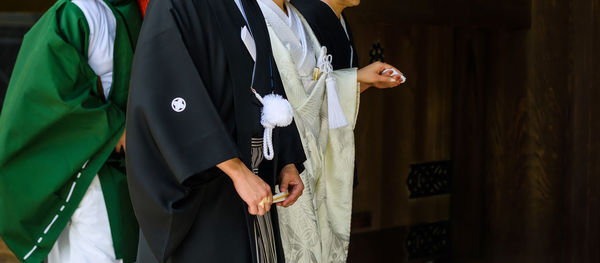 Midsection of females in traditional clothing at temple