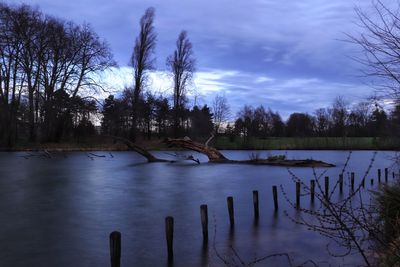 Scenic view of lake against sky at dusk