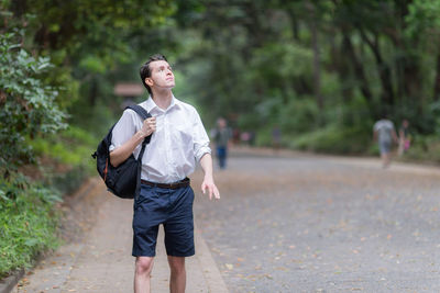 Full length of young man standing on road