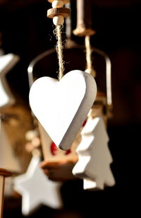 Close-up of heart shape hanging on metal