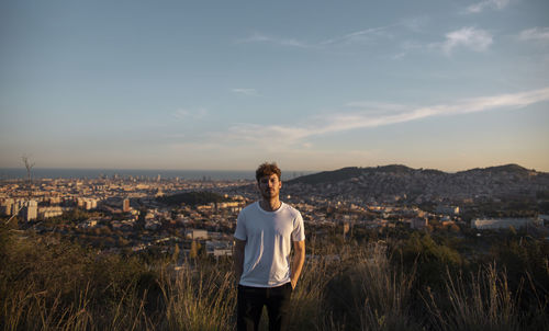 Full length of man standing in city against sky