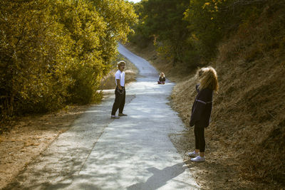 Rear view of woman walking on footpath