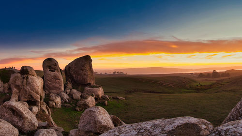 Scenic view of rock formations against sky during sunset