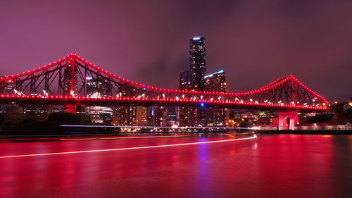 Illuminated golden gate bridge over river at night