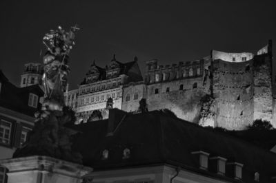 Low angle view of old buildings against sky at night