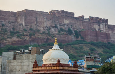 City construction with ancient fort background at day form flat angle