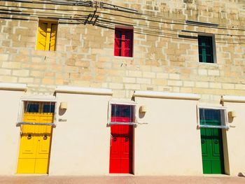 Red door of yellow building