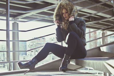 Young woman sitting on steps