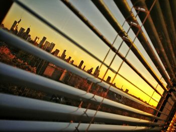 Window shades view of sky in city