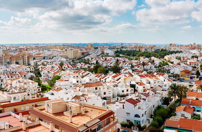 High angle view of houses in town against sky