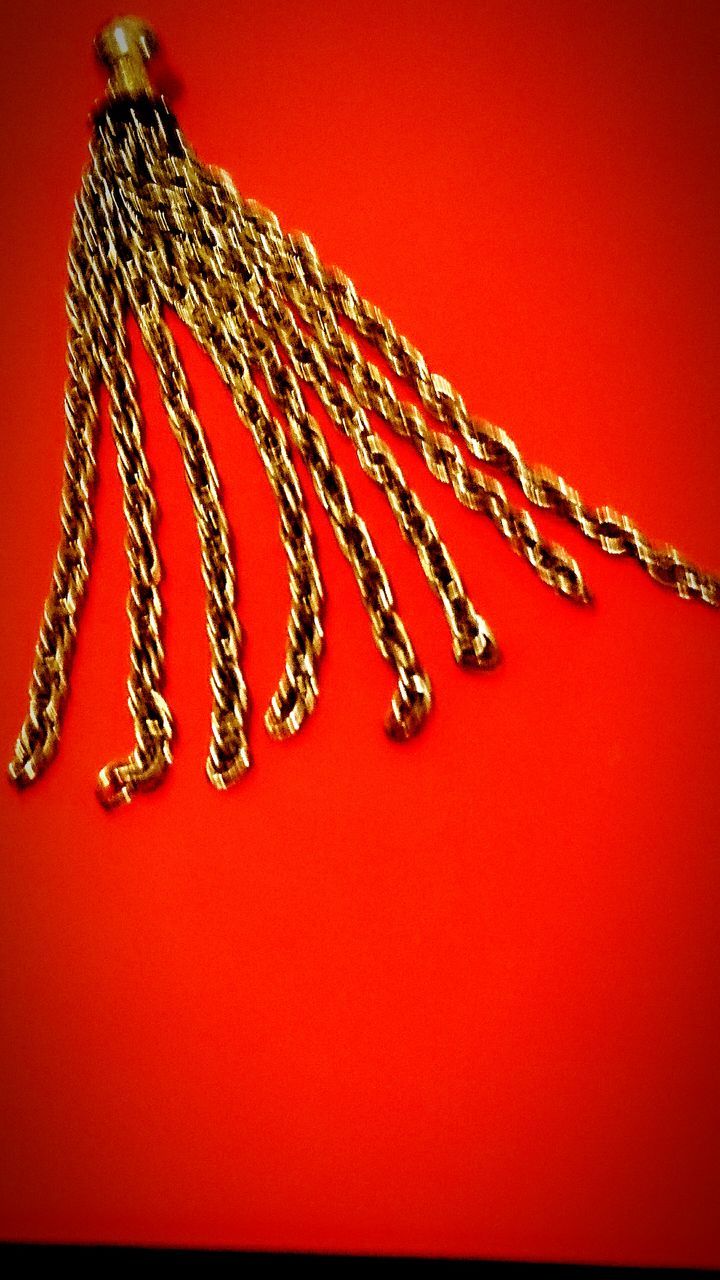 red, decoration, hanging, close-up, studio shot, pattern, copy space, celebration, wall - building feature, art and craft, tradition, design, indoors, cultures, no people, low angle view, art, fabric, multi colored, vibrant color