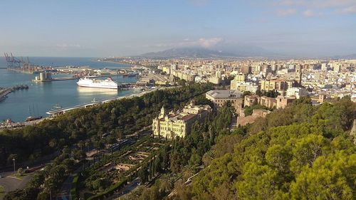 High angle view of townscape by sea against sky