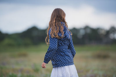 Midsection of woman standing on field