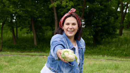 Portrait of smiling young woman holding ice cream