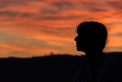 Portrait of silhouette man against orange sky