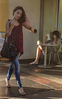 Full length of woman standing against wall