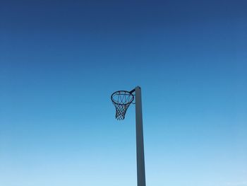 Low angle view of basketball hoop against blue sky