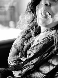 Close-up of woman sticking out tongue